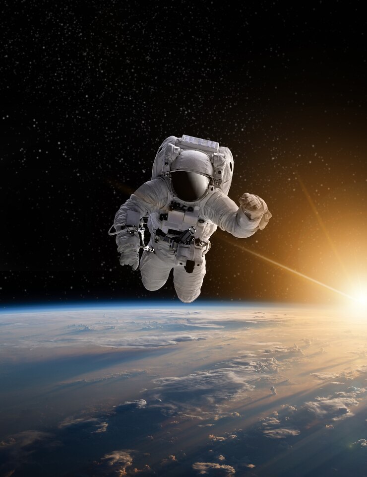 Foto astronauta en el espacio exterior sobre el planeta tierra. las estrellas proporcionan el fondo. realizando un espacio sobre el planeta tierra. salida del sol, puesta del sol. nuestro hogar. iss. elementos de esta imagen proporcionados por la nasa.