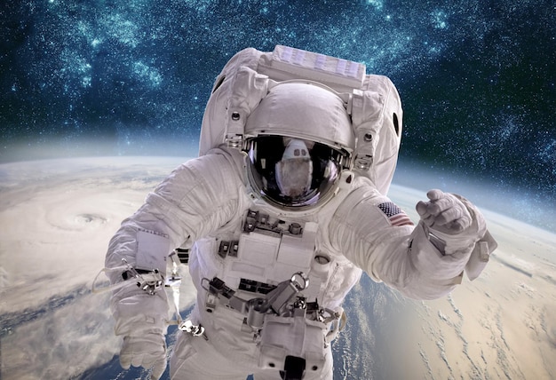 Astronauta no espaço sideral contra o pano de fundo do planeta Terra. Tufão sobre o planeta Terra. Elementos desta imagem fornecidos pela NASA.