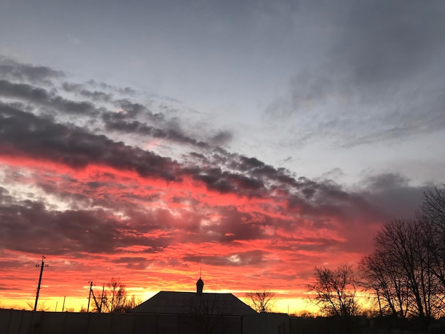 Un atardecer con una casa al fondo