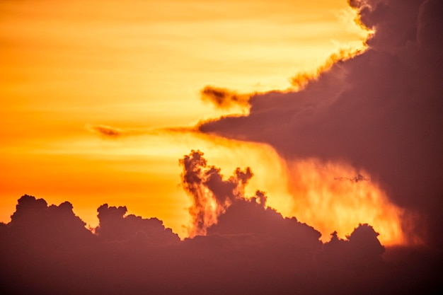 Un atardecer con una nube en el cielo