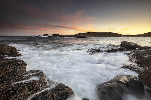 Atemberaubender Sonnenuntergang über dem Ozean voller großer Felsen in St. Agnes, Isles Of Scilly, Cornwall, Großbritannien