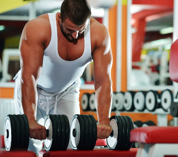 Athletischer Bodybuilder, führen Übung in der Sportturnhallenhalle durch