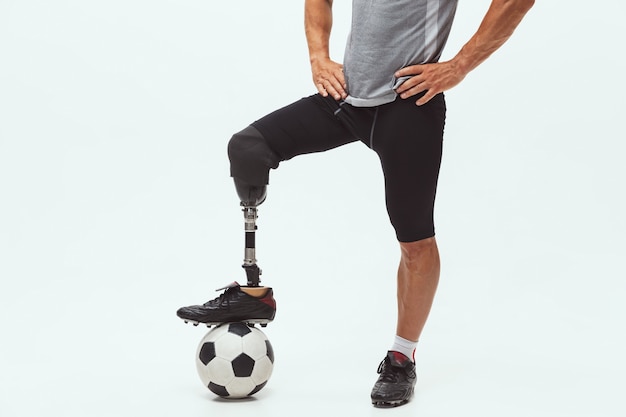 Foto atleta con discapacidad o amputado en el fondo del estudio. jugador de fútbol