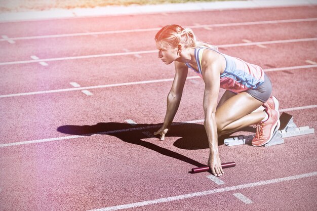 Atleta femenina lista para comenzar la carrera de relevos