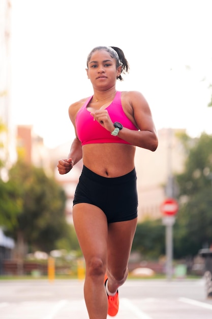 Foto atleta feminina correndo durante seu treinamento na cidade