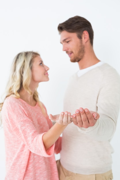 Atractiva pareja joven sosteniendo palmas