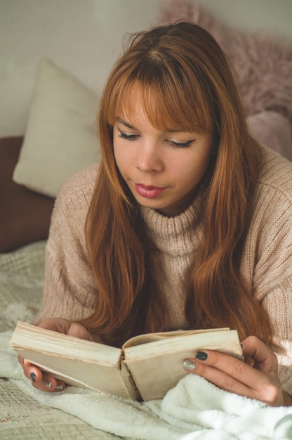 Attraktive junge Frau liest zu Hause ein Buch