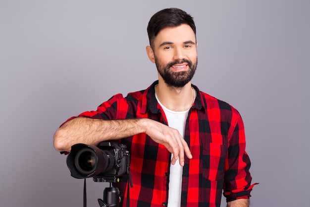 Foto attraktiver glücklicher junger fotograf mit großem zoomobjektiv