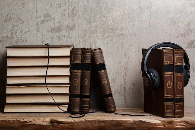 Audiobooks, fones de ouvido na pilha de livros