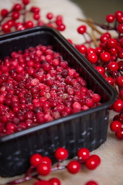 auf dem Tisch in einer Schüssel rote Beeren reif mit Eis gefroren