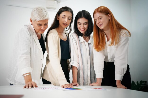 Aufnahme einer reifen Geschäftsfrau, die im Büro sitzt und ihr Team trainiert