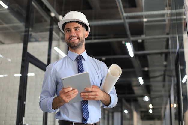 Aufnahme eines Ingenieurs mit einem digitalen Tablet auf einer Baustelle.