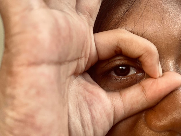 Augen zwischen zwei Fingern