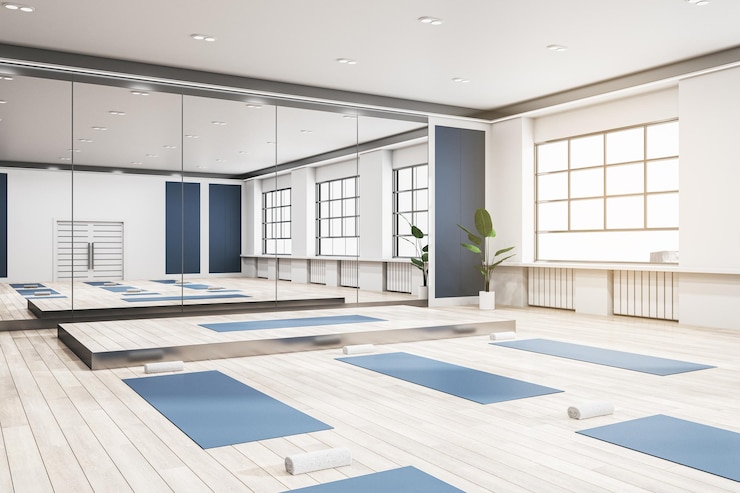 Foto aula de grupo contemporânea no interior do ginásio com tapetes de ioga azuis, espelho de piso de madeira com janela de reflexos com vista para a cidade e renderização 3d à luz do dia