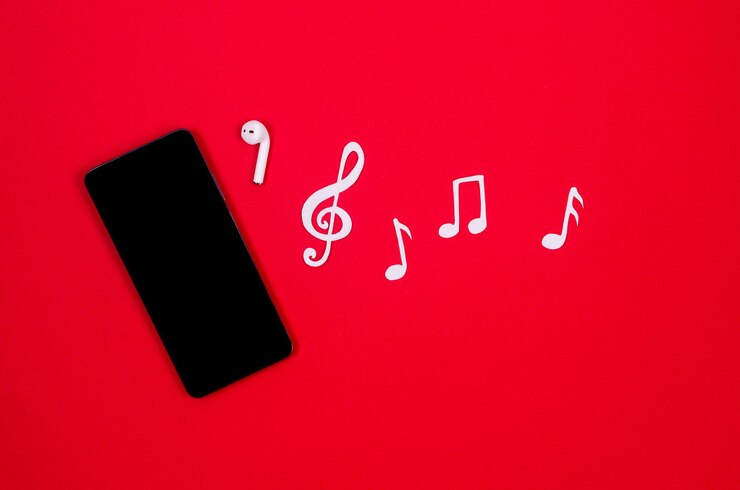 Foto auriculares inalámbricos de teléfono blanco con notas musicales y clave de sol