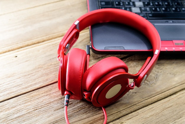 Auriculares rojos colocados en la laptop o notebook negra