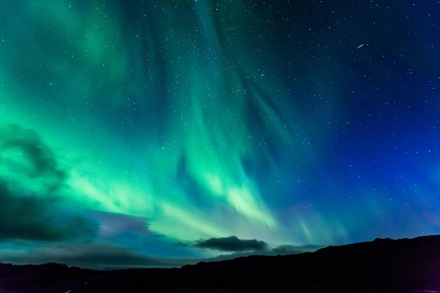 Aurora à noite sobre a terra como pano de fundo