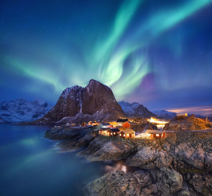 Aurora Borealis auf den Lofoten Norwegen Grüne Nordlichter über dem Meer Nachthimmel mit Polarlichtern Nächtliche Winterlandschaft mit Polarlichtern und Spiegelungen auf der Wasseroberfläche Norwegenbild