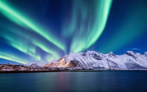 Aurora Borealis Islas Lofoten Noruega Nohen montañas ligeras y océano Paisaje de invierno por la noche Imagen de viaje de Noruega