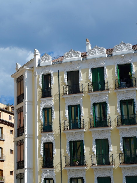 Auténtica fachada chic de edificio barroco con elegantes ventanas redondeadas molduras de estuco Madrid España