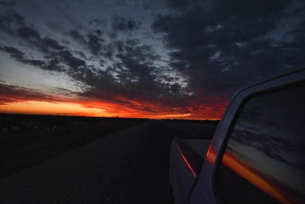 Foto auto auf der straße gegen den himmel bei sonnenuntergang