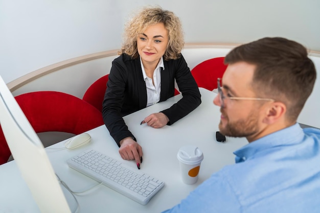 Autohaus-Manager mit Kunden am Computer