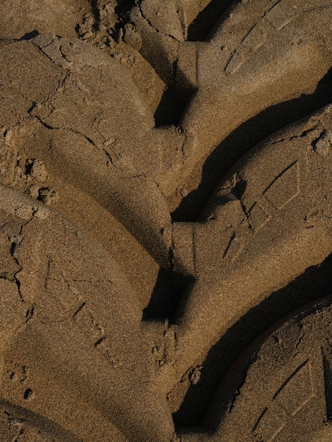 Autoreifenabdrücke auf Sand