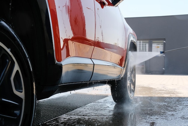 Autowäsche mit Hochdruckwasser Auto in Schaum Autowäsche