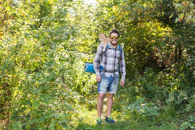 Aventuras, turismo de verano y concepto de naturaleza: turista que llega a un camping con su gato.