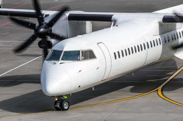 Avião de passageiros para taxiar no cockpit da plataforma do aeroporto e aparafusar o fechamento do motor da aeronave