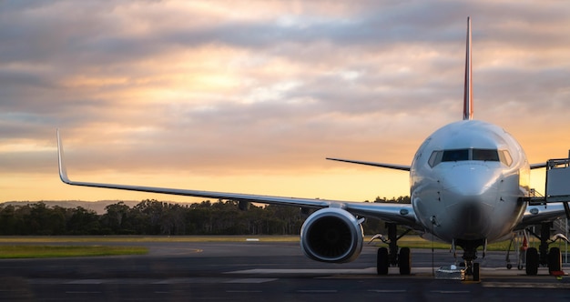 Avião na pista do aeroporto ao pôr do sol na Tasmânia