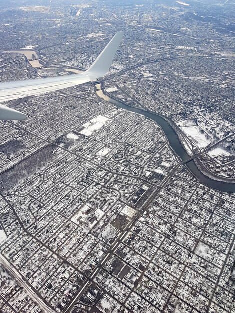 Foto avião voando sobre a paisagem urbana