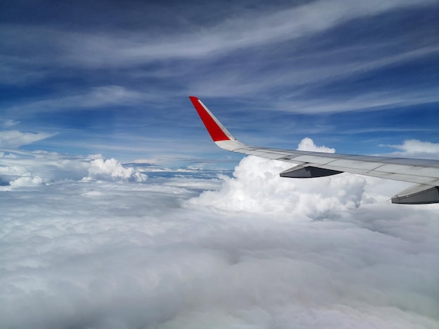 Avião voando sobre nuvens contra o céu