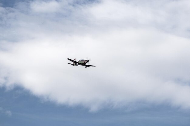 Un avión militar en el cielo volando con el cielo nublado
