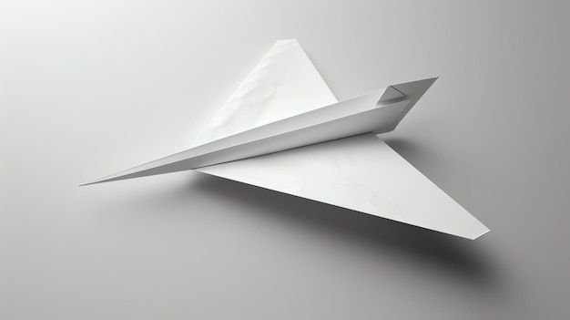 Foto un avión de papel blanco está volando en un fondo blanco el avión está hecho de una sola hoja de papel y está plegado en un diseño simple