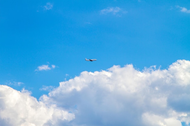 Avión de pasajeros alto en el cielo en las nubes