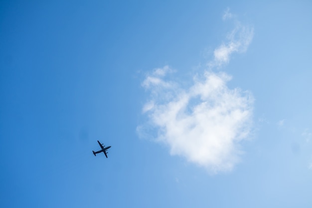 Avión de pasajeros volando sobre fondo de cielo azul