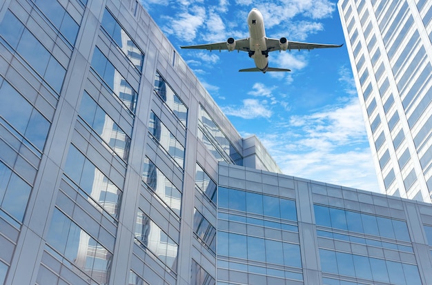 Avión volando en el cielo por encima de un moderno edificio de oficinas de vidrio sostenible Exterior rascacielos verde