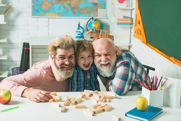 Avô pai e filho jogando jogos geração de homens menino feliz abraça jovem pai e el