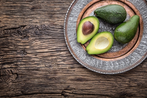 Avocado. Schneiden Sie Avocado auf einem Hintergrundtisch aus Eichenholz. Selektiver Fokus.