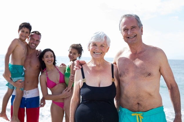 Avós sorridentes com família na praia