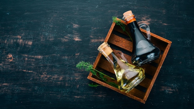 Azeite e molho de soja em frascos de vidro Especiarias e molho Vista superior Em um fundo preto de madeira Espaço livre para texto