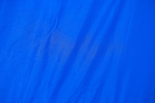 Azul amassado velho com fundo áspero da textura do papel da página do tecido da barraca. vinco grunge padrão de pergaminho design vintage