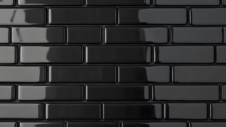 Los azulejos rectangulares negros brillantes dispuestos en un patrón de ladrillo