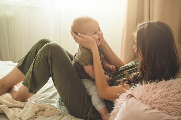 Baby mit Mutter auf dem Bett