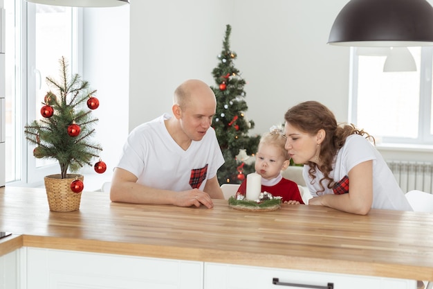 Babykind mit Hörgerät und Cochlea-Implantat, das Spaß mit den Eltern im Weihnachtsraum hat, taub div