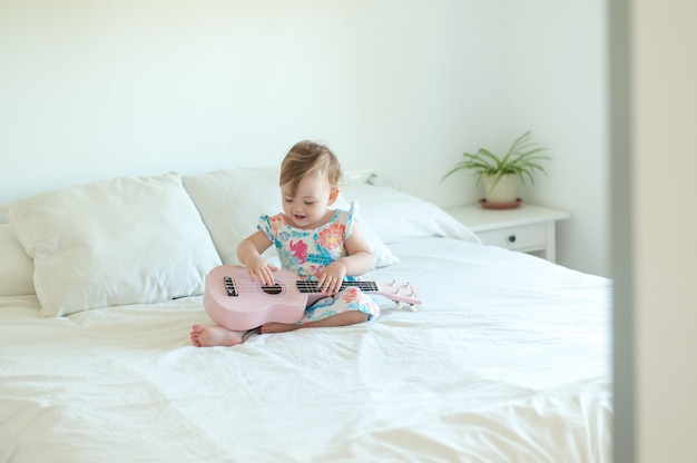 Babymädchen, das Ukulele spielt