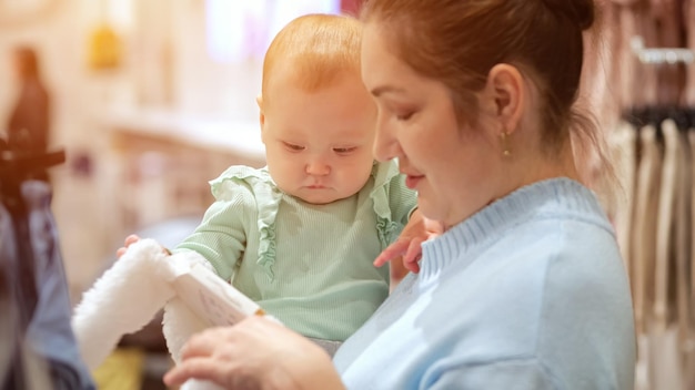 Foto babymädchen mit mutter wählen kleidung