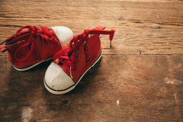 Foto babyschuhe auf hölzernem hintergrund