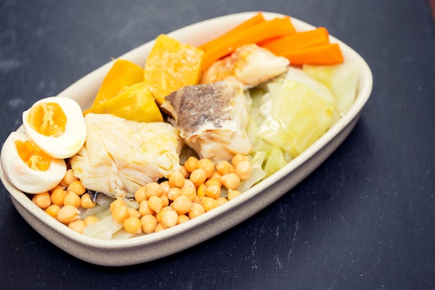 Bacalao hervido con verduras hervidas en plato